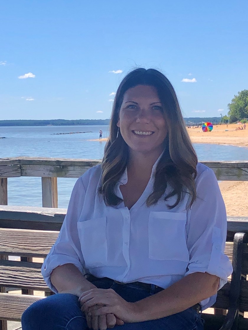 Young girl with long dark hair smiling.